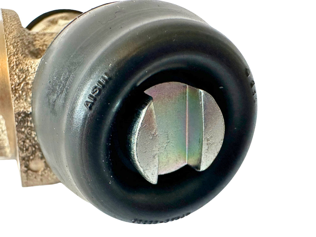 Close-up of a black rubber boot of a brake wheel cylinder with metal shaft on a white background