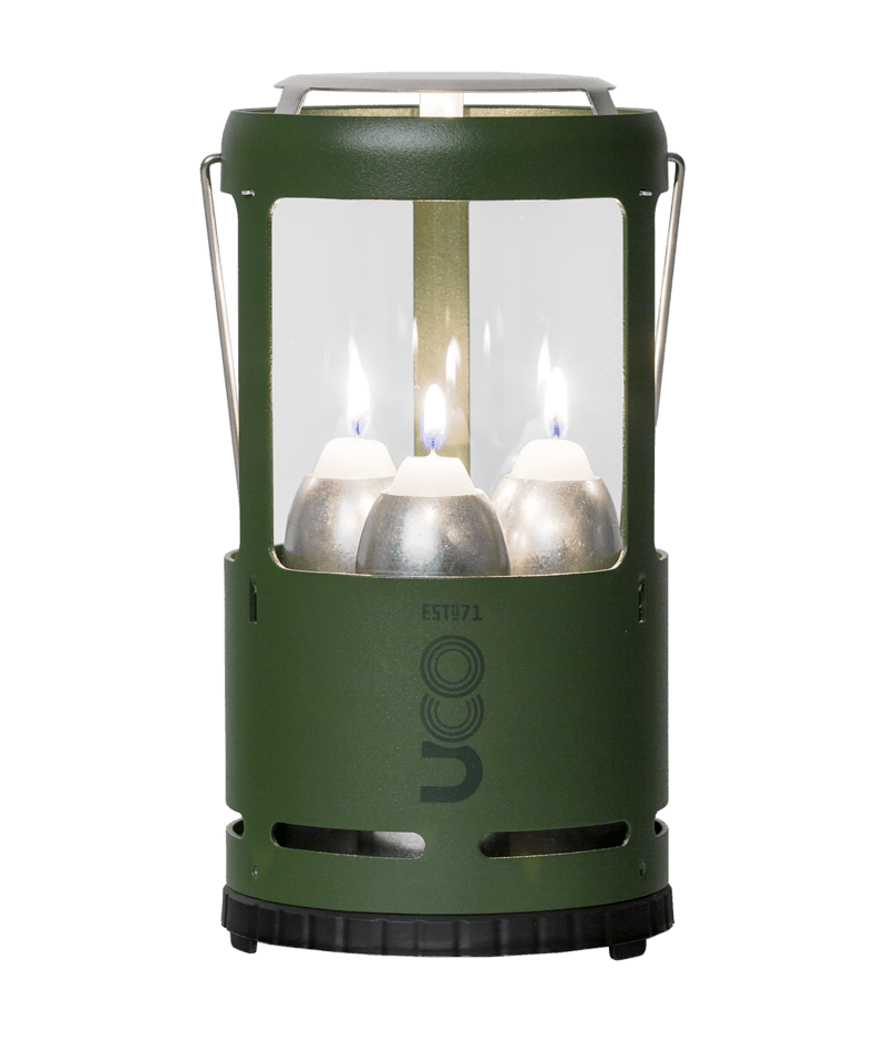 Green lantern with three lit candles inside on a transparent background