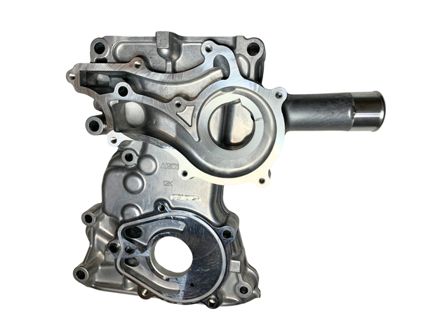 Metal engine component timing cover on a white background