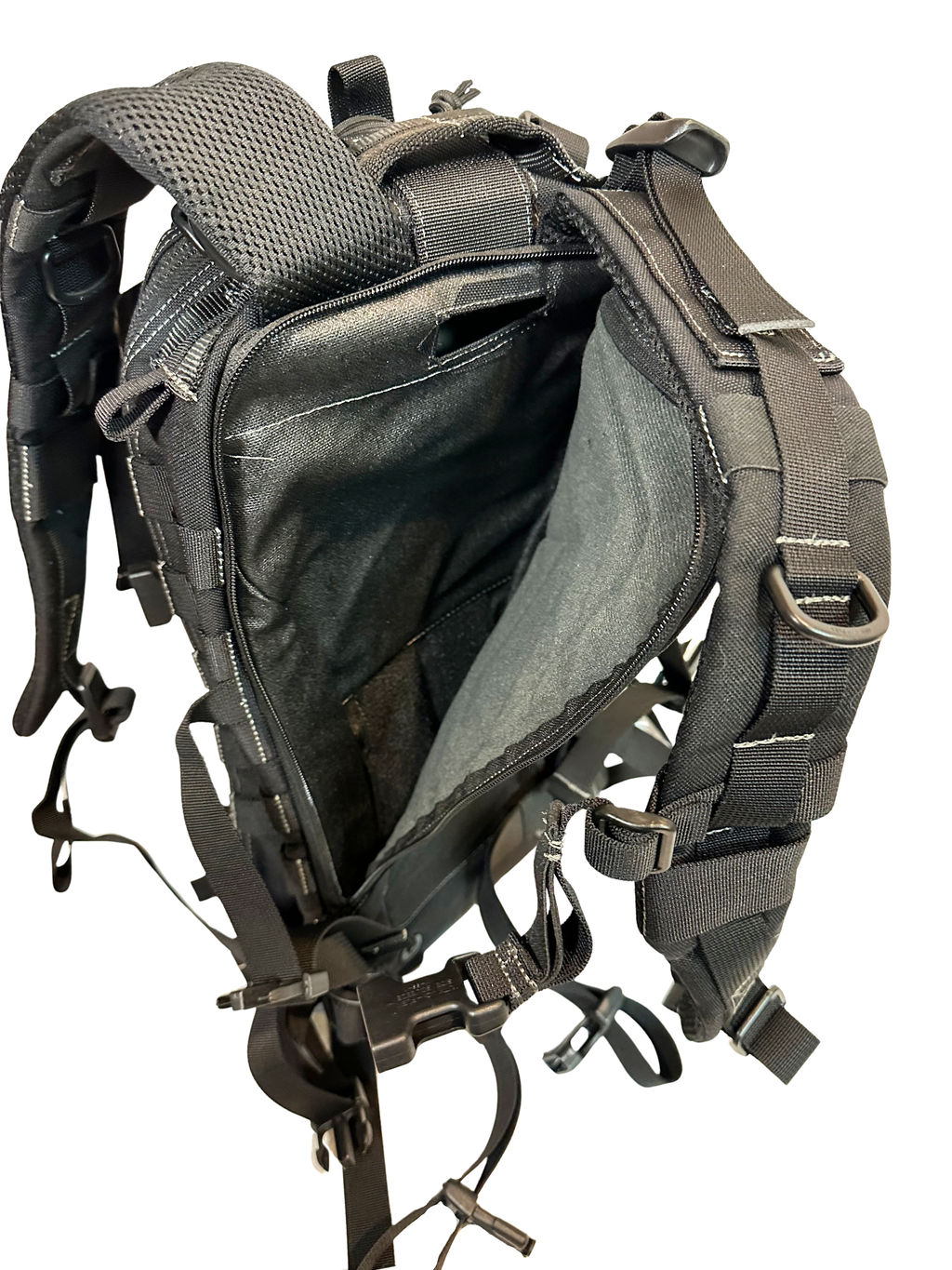 Close-up of a tactical backpack with open compartment on a white background