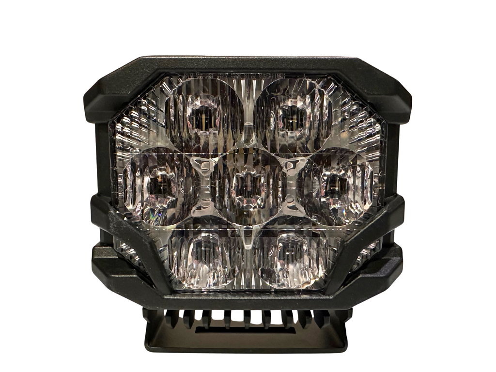 Cube-shaped LED light with clear lens and black frame on a white background